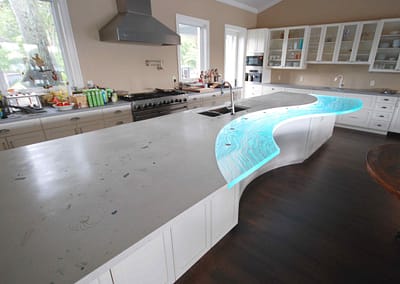 Seashells in huge long Concrete Countertop with Textured Glass component in Sarasota Florida with LED light