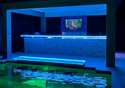 Glass Countertops in pool cabana with LEDs glowing