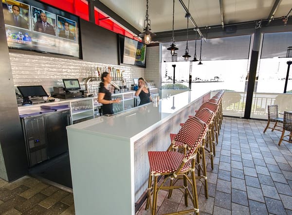 White Countertop outdoor Bar with waterfall edge at American Social restaurant in Tampa Fl